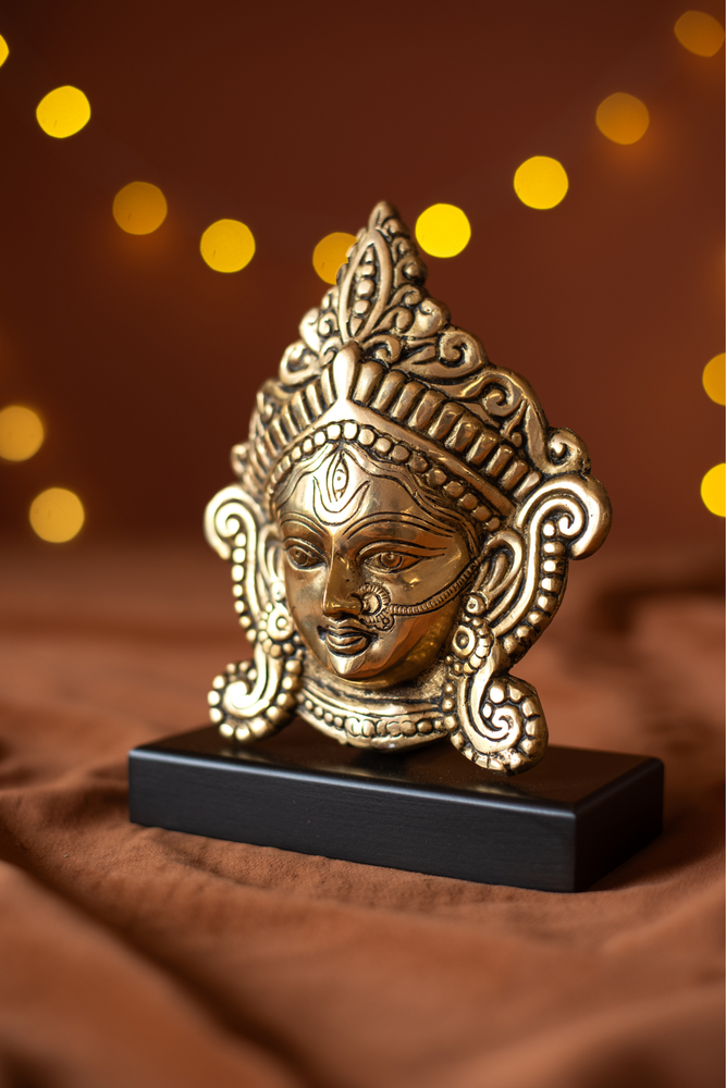 
                  
                    Brass Durga Face With Wood Stand
                  
                