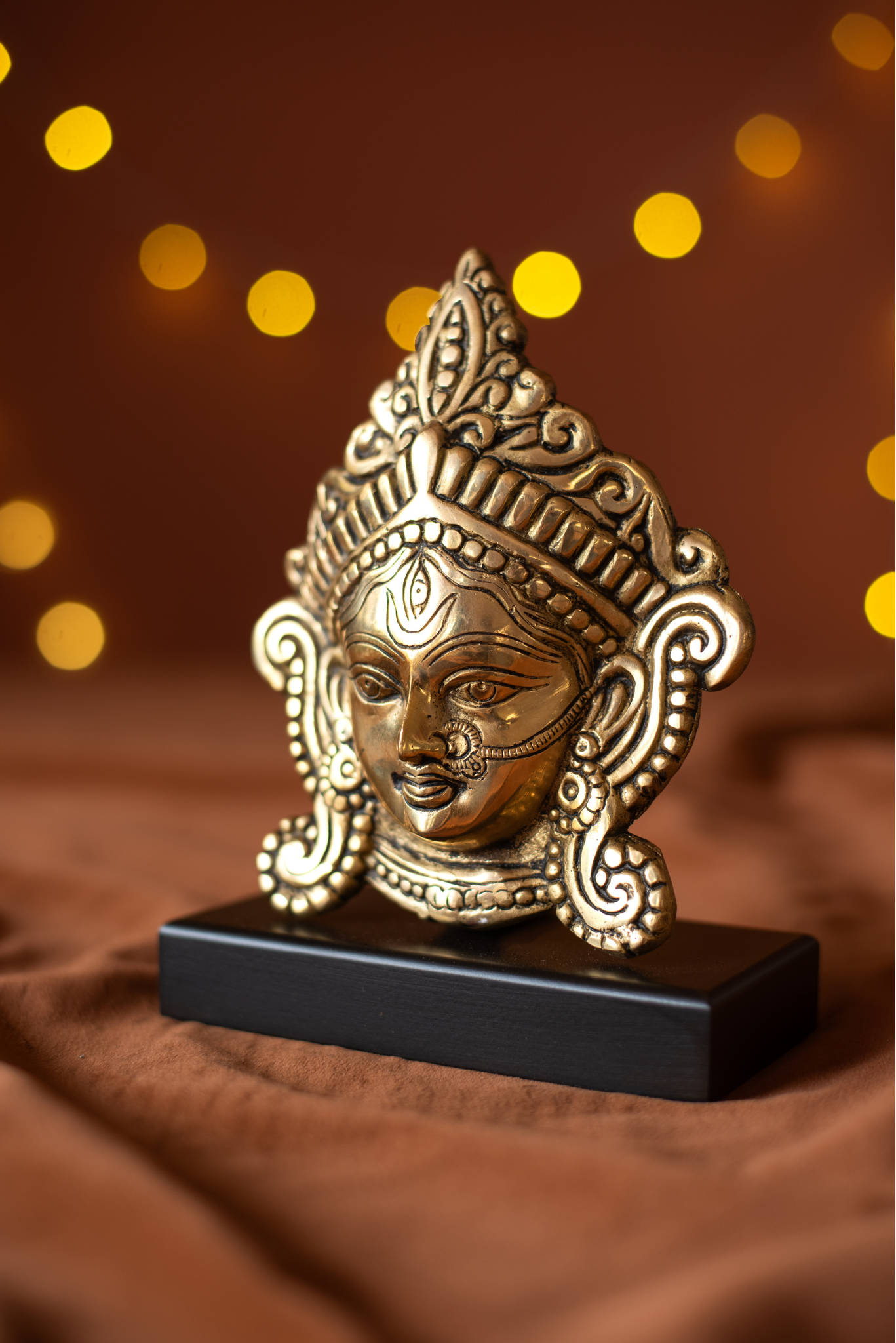 
                  
                    Brass Durga Face With Wood Stand
                  
                